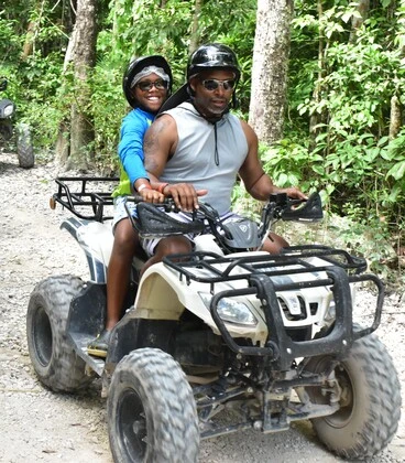 Person driving an ATV through the rainforest at Loma Bonita Ecopark