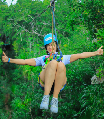 Visitor ziplining over the jungle at Loma Bonita Ecopark